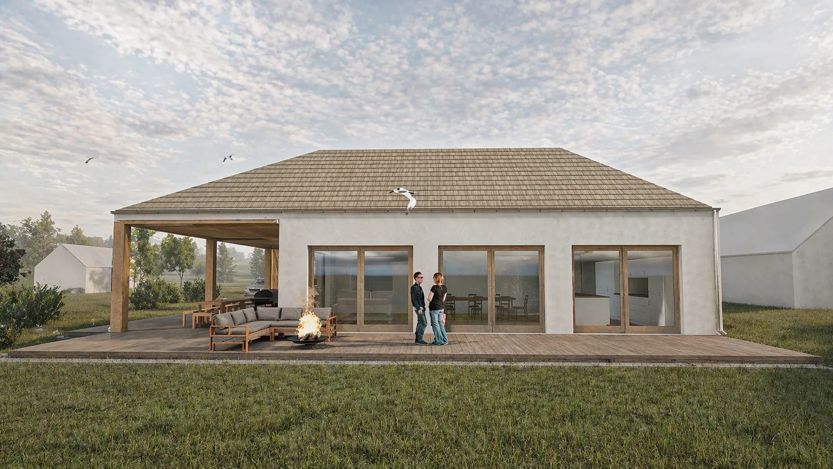 A ház hátsó homlokzata a panorámaüvegekkel és a kerti tűzrakóhellyel